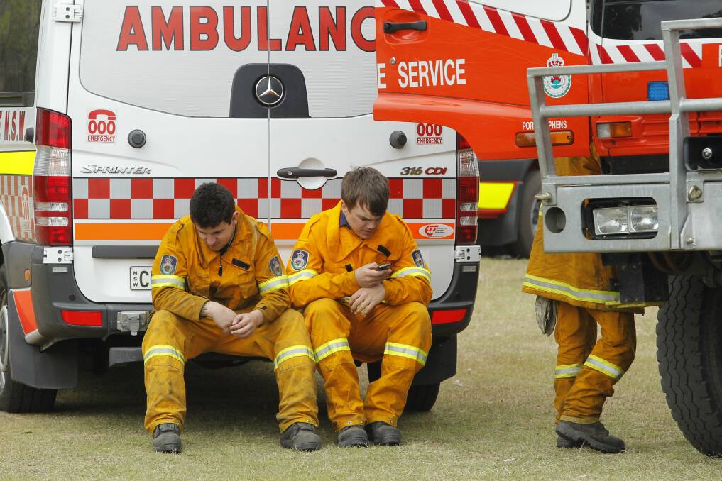 NSW Rural Fire Service crew resting at Finnan Park, Campvale. Picture: Max Mason-Hubers
