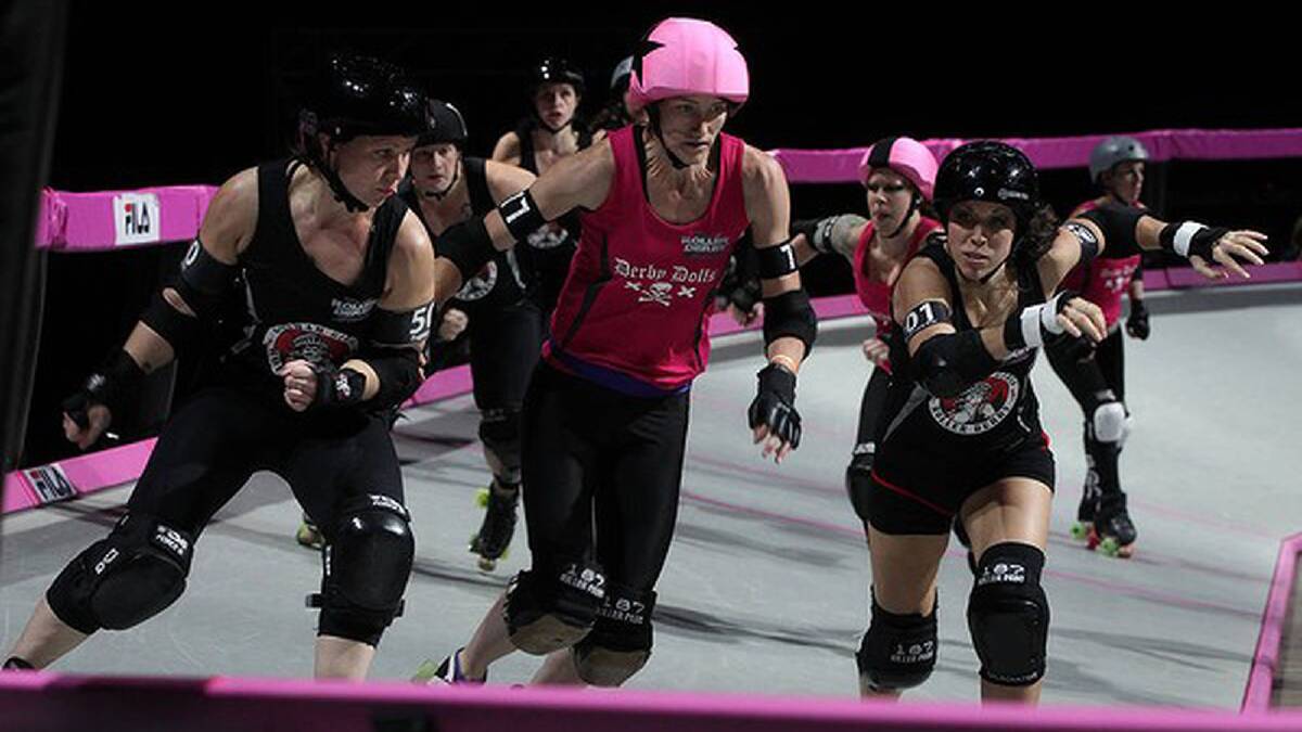 Two Gotham City girls prepare to put the squeeze on a Derby Doll. Photo: Danielle Smith