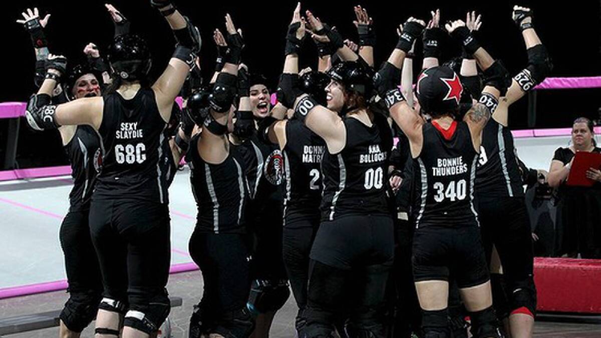 The NY Gotham Girls celebrate their win. Photo: Janie Barrett