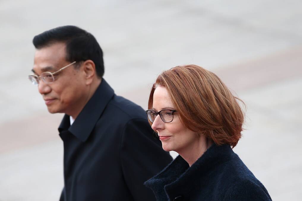 Chinese Premier Li Keqiang accompanies Australian Prime Minister Julia Gillard to view an honour guard during a welcoming ceremony outside the Great Hall of the People in Beijing, China. Photo: Getty Images