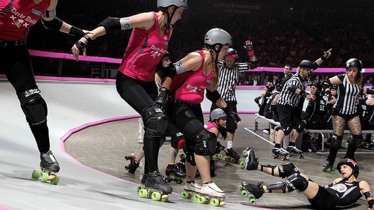 A group of Derby Dolls make sure one of the Gothams lands out of play. Photo: Janie Barrett