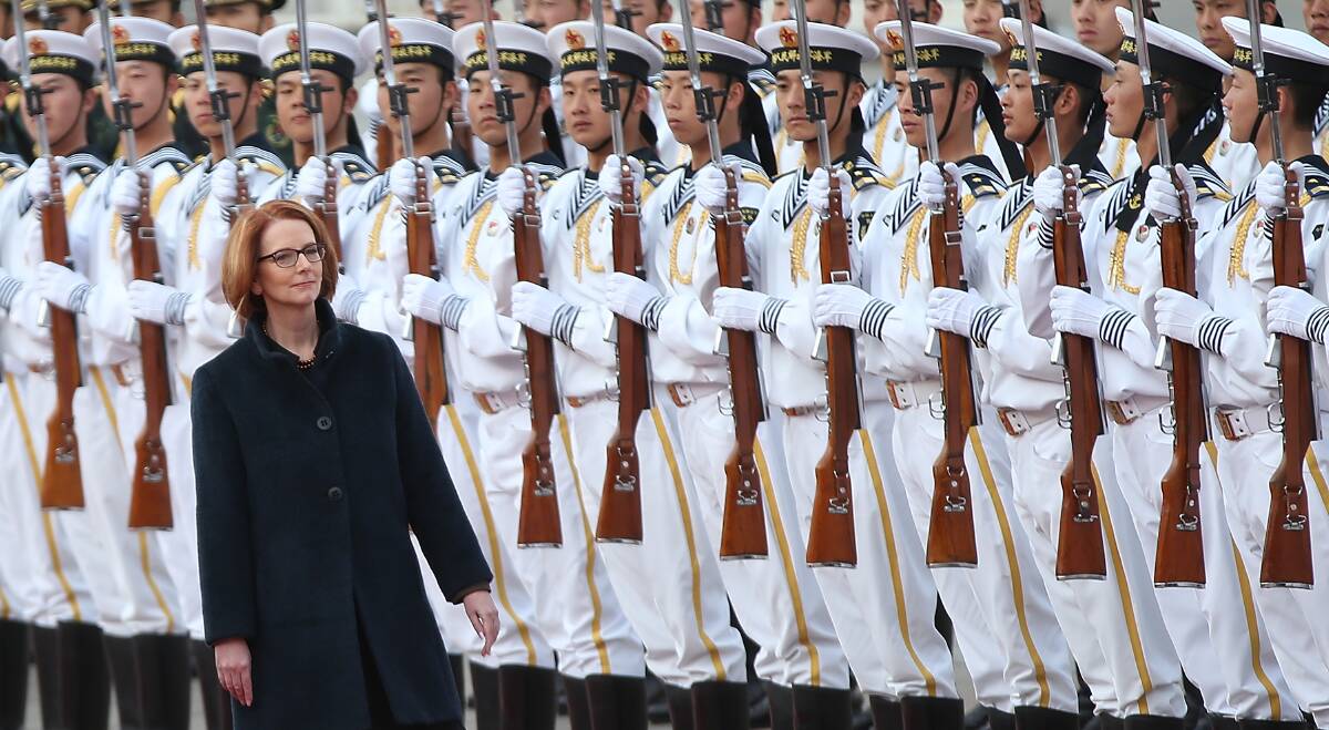 Chinese Premier Li Keqiang accompanies Australian Prime Minister Julia Gillard to view an honour guard during a welcoming ceremony outside the Great Hall of the People in Beijing, China. Photo: Getty Images