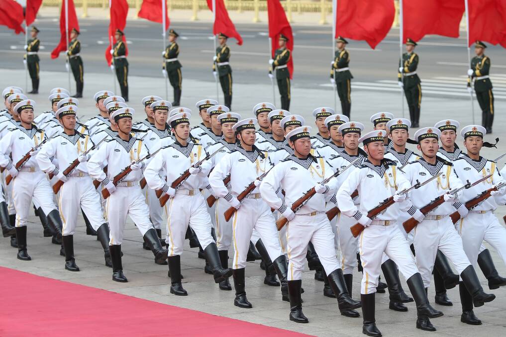Honour guard troops march during a welcome ceremony for Australia's Prime Minister Julia Gillard outside the Great Hall of the People in Beijing, China. Photo: Getty Images