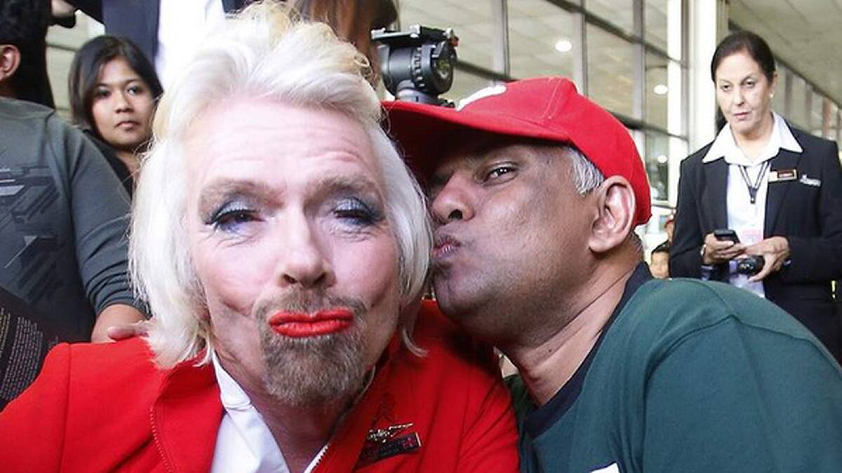 AirAsia's Chief Executive Tony Fernandes pretends to kiss British entrepreneur Richard Branson. Photo: Bazuki Muhammad