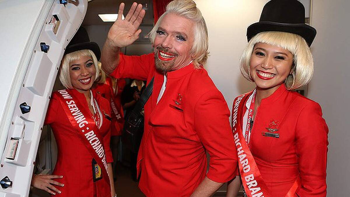 Sir Richard Branson waves farewell prior to his flight to Kuala Lumpur. Photo: Paul Kane