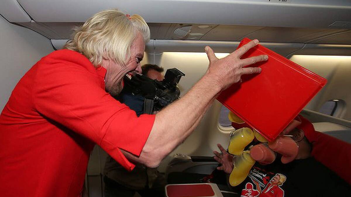 Sir Richard Branson tips a tray of drinks onto Air Asia chief Tony Fernandes. Photo: Paul Kane