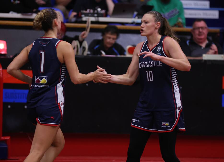 Newcastle Falcons import Nicole Munger (right) scored 29 points and hauled in 21 rebounds against Bankstown. Picture by Grant Sproule 